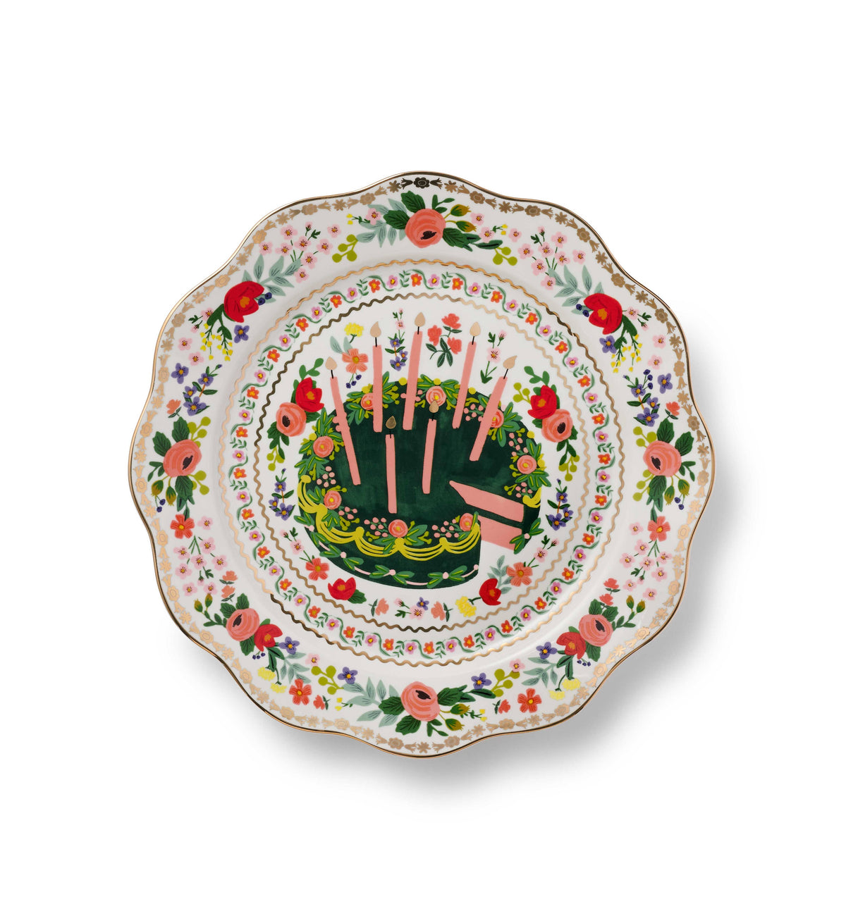 Rifle Paper Co. Floral Cake Celebration Plate overhead view; scalloped ceramic plate with illustrated green birthday cake and pink candles at center; concentric rings of painted poppies, roses, and wildflowers; gold rim; white background
