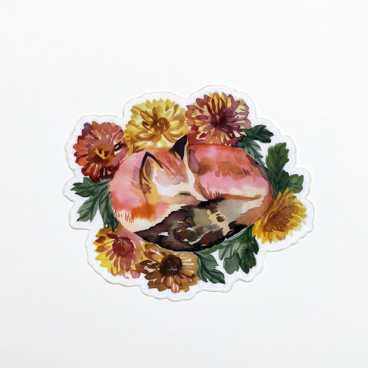 Made by Shellie Sleeping Fox vinyl sticker — watercolor red fox curled up sleeping in a wreath of marigolds, sunflowers, and dahlias in warm autumn reds, golds, and oranges; die-cut with scalloped white border; white background