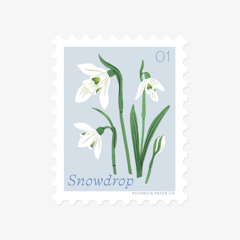 Botanica Paper Co. Snowdrop vinyl stamp sticker — illustrated white snowdrop blooms with green stems on soft powder blue background; perforated stamp edges; "Snowdrop" lettered at bottom; numbered 01; light gray background