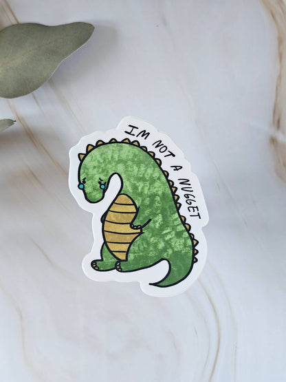 Sad Dino Nugget Vinyl Sticker Cute Green Dinosaur - Waterproof sticker for Water bottle, UV sealed