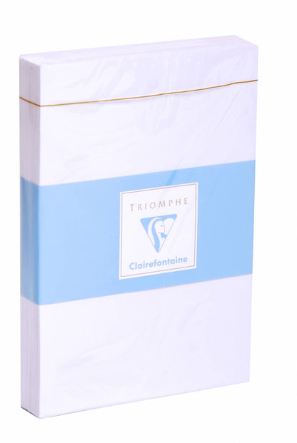 Clairefontaine Triomphe envelope box on white background — slim rectangular white box with gold foil top edge; pale blue band across center printed with "TRIOMPHE" in grey text above the Clairefontaine sailing ship logo in a white square frame and "Clairefontaine" wordmark in blue script below