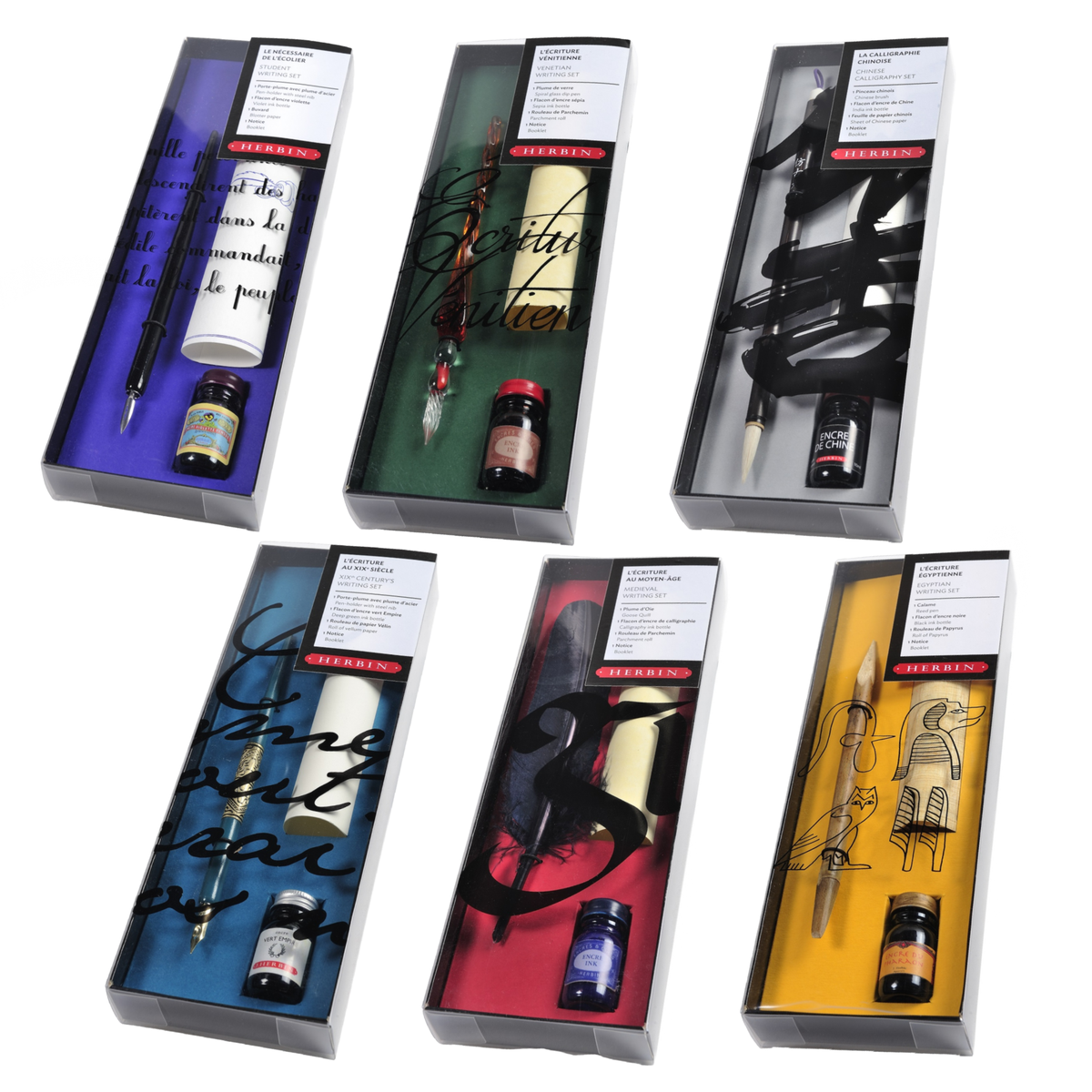 All six J. Herbin History of Writing pen and ink gift sets shown open in their display boxes on white background — top row (left to right): 19th Century Student (purple lining), Carnevale Venezia (green with glass spiral pen), Chinese Calligraphy (dark with Chinese brush); bottom row: Belle Époque (blue with ornate nib holder), Medieval (red with goose quill), Egyptian (yellow with bamboo reed pen and papyrus); each box shows pen, ink bottle, and paper sheet

