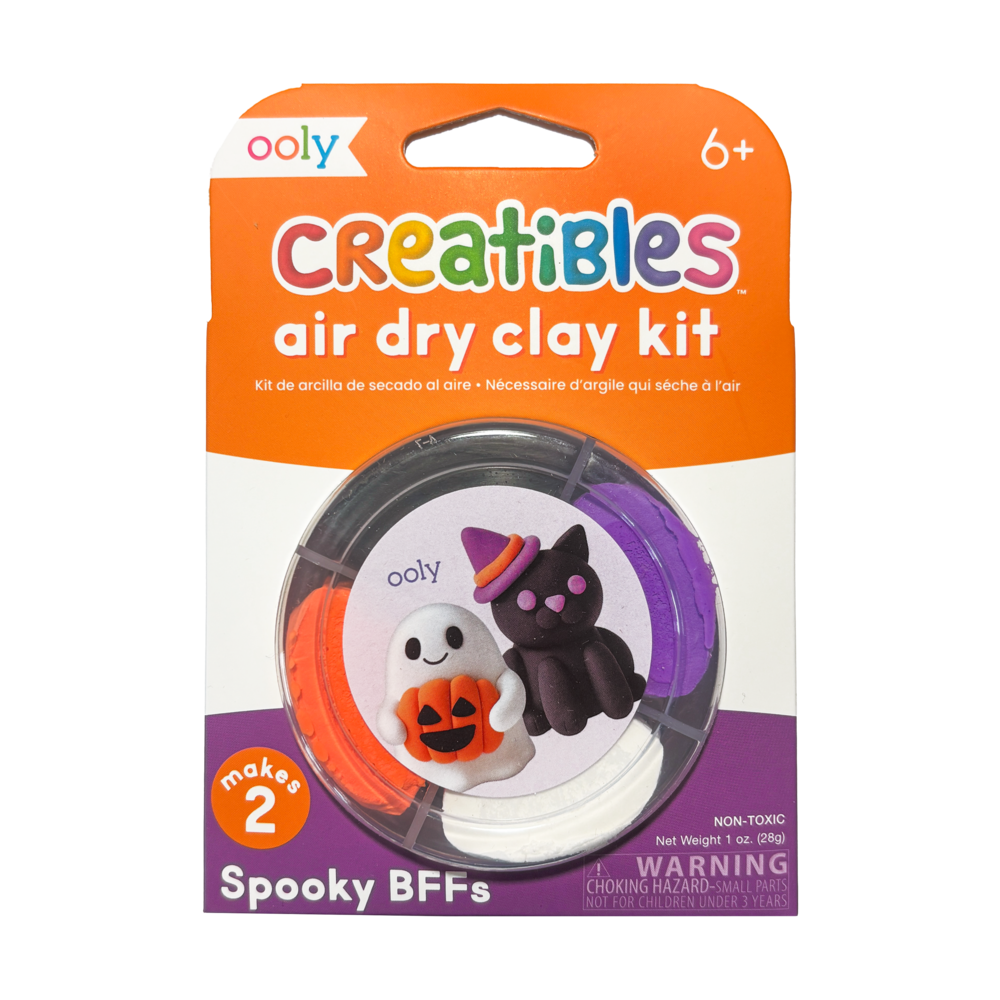 Front of OOLY Creatibles Air Dry Clay Kit — Spooky BFFs round tub packaging showing ghost and black cat with witch hat figurines on label — "makes 2," non-toxic, net weight 1 oz. (28g), ages 6+