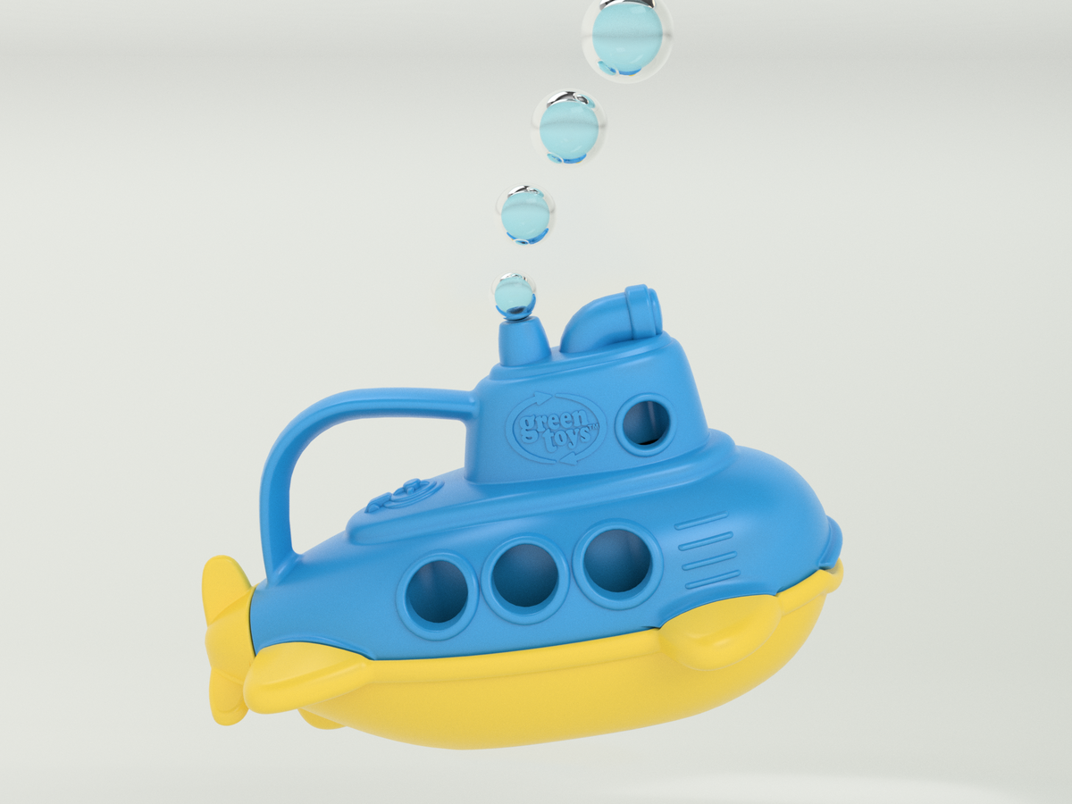 Green Toys Bubbling Submarine product render on light grey background — blue and yellow submarine shown in three-quarter view floating with four illustrated water bubbles rising from the periscope in a diagonal trail above; Green Toys logo embossed on the side hull; yellow tail fins and rudder visible at rear