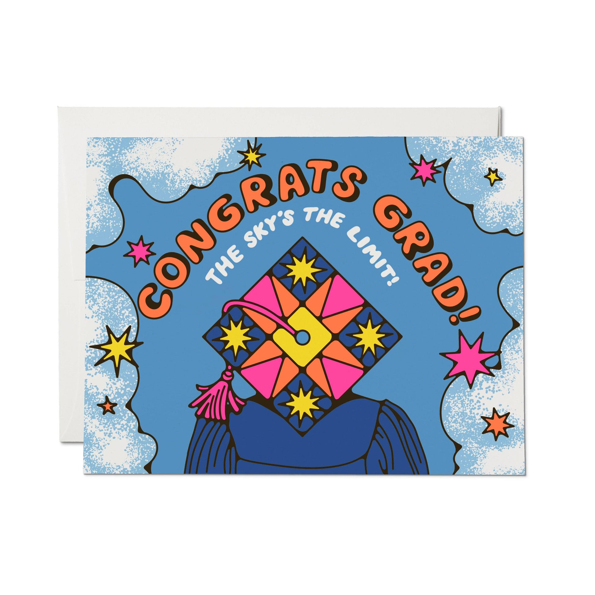 Red Cap Cards Sky's the Limit Graduation Greeting Card — illustrated card with bold "Congrats Grad! The Sky's the Limit!" text on a blue sky background with clouds, colorful stars, and a decorated graduation cap with pink tassel; white envelope shown behind; white background