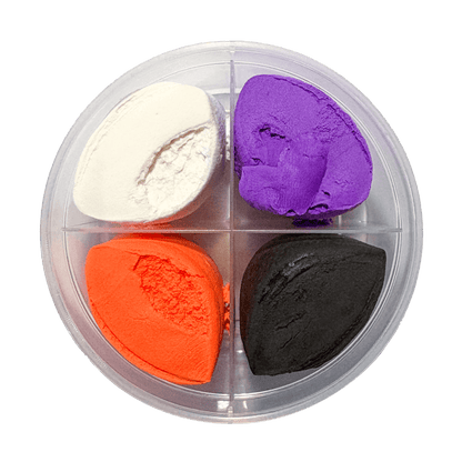 Top-down view of open OOLY Creatibles Spooky BFFs round clay tub showing four air dry clay colors: white, purple, orange, and black