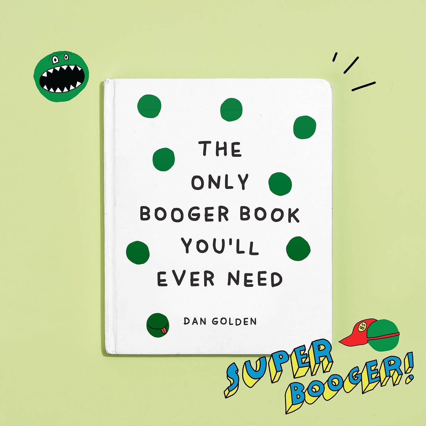 The Only Booger Book You'll Ever Need cover displayed on a light green background with playful illustrated stickers — a green monster booger character in the upper left and a "Super Booger!" comic-style badge with a caped booger in the lower right