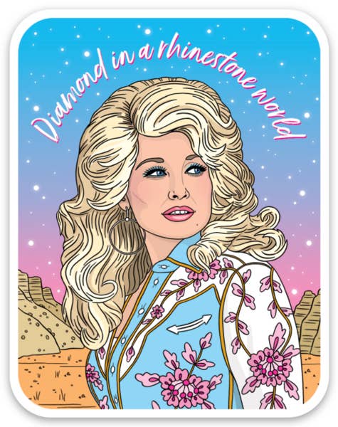 The Found Dolly Diamond in a Rhinestone World Die Cut Sticker — illustrated portrait of Dolly Parton with voluminous blonde hair in a floral western jacket against a pink and blue desert sunset sky with stars, with "Diamond in a rhinestone world" in pink cursive script arched above; white die-cut border; white background