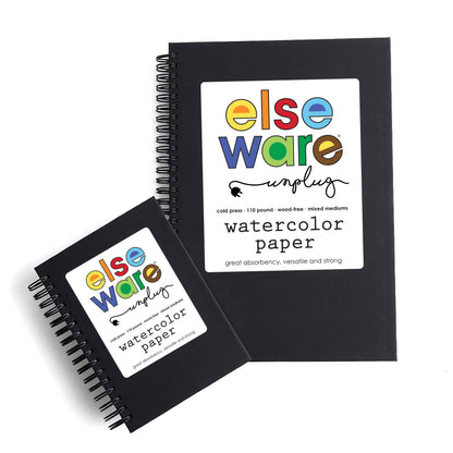 Two Elseware Unplug watercolor paper pads on white background showing size comparison — large pad upright in background with white label showing colorful Elseware Unplug logo; small pad angled in foreground; both are black spiral-bound with identical cold press watercolor paper branding