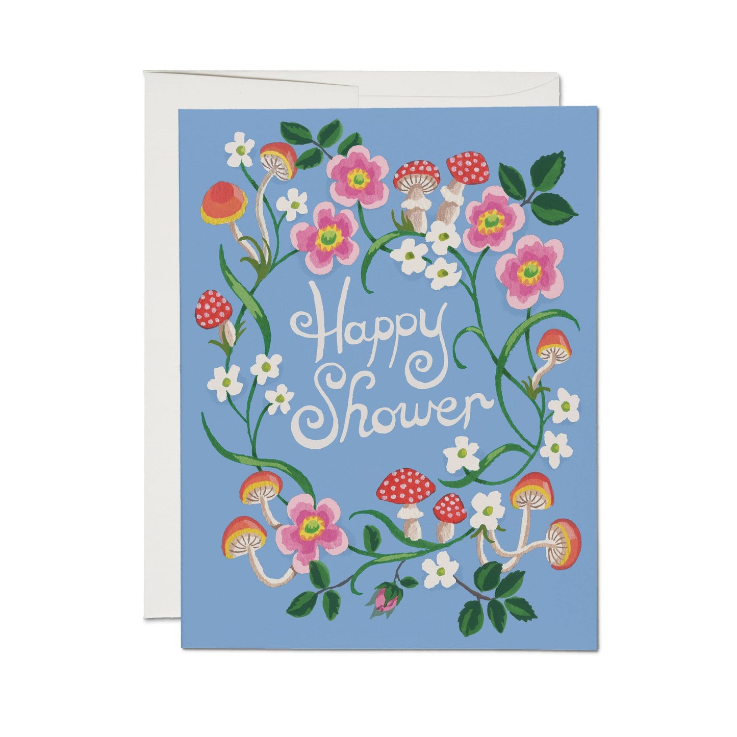 Red Cap Cards Woodland Wishes Happy Shower Greeting Card — illustrated card with "Happy Shower" in white script surrounded by a wreath of pink roses, white wildflowers, red and orange mushrooms, and green vines on a periwinkle blue background; white envelope shown behind; white background