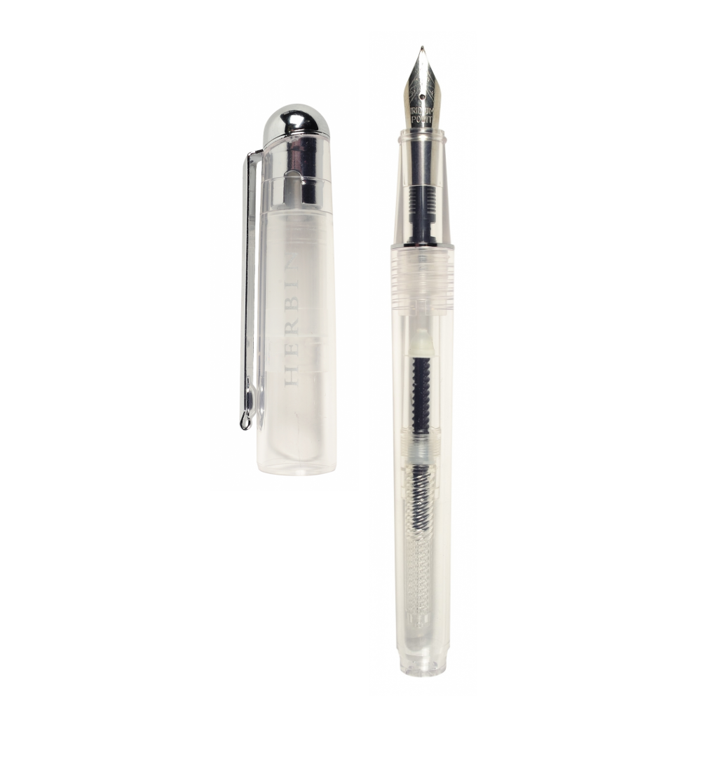 J. Herbin Demonstrator fountain pen on white background — clear transparent barrel with piston converter and dark ink residue visible inside; steel iridium nib with silver-tone section and grip; cap removed and placed to left showing silver dome finial, clip, and frosted body with embossed Herbin text