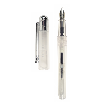 J. Herbin Demonstrator fountain pen on white background — clear transparent barrel with piston converter and dark ink residue visible inside; steel iridium nib with silver-tone section and grip; cap removed and placed to left showing silver dome finial, clip, and frosted body with embossed Herbin text