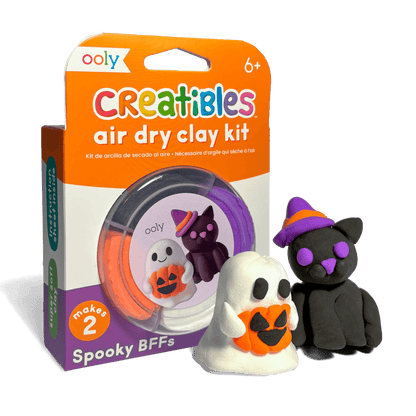 OOLY Creatibles Air Dry Clay Kit — Spooky BFFs front packaging showing completed ghost holding jack-o-lantern and black witch cat figurines alongside the round clay tub — "makes 2," ages 6+