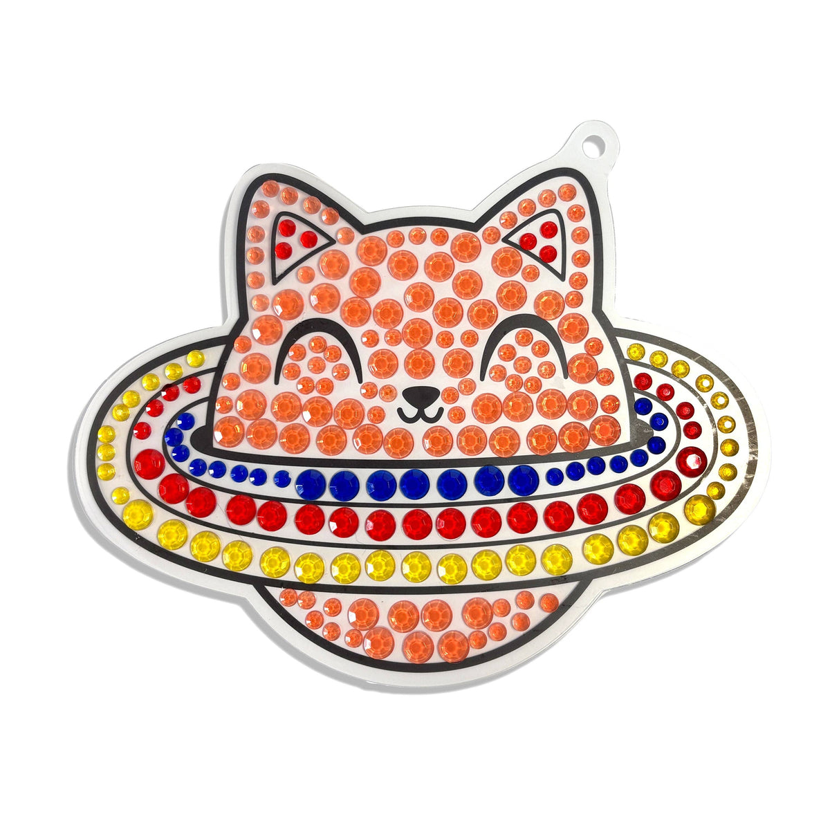 Close-up of completed OOLY Sun Sparkles space cat with planet ring gem suncatcher on white background, decorated with orange, red, blue, and yellow sticker gems