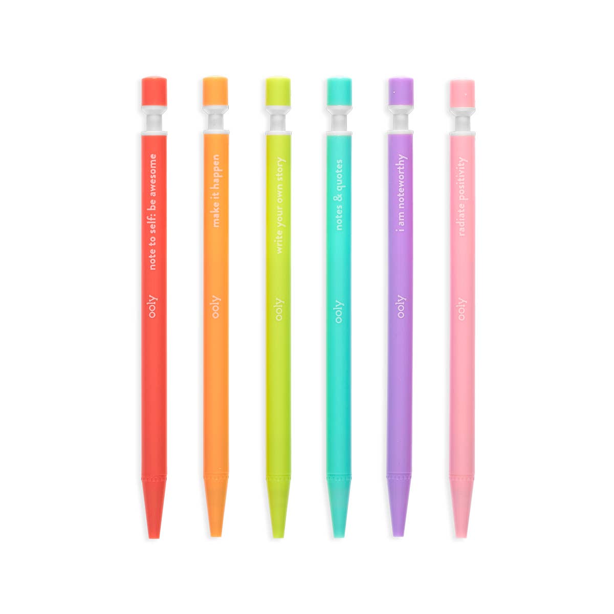 Six OOLY Noted! mechanical pencils laid flat in a row on a white background — left to right in rainbow order: red, orange, lime green, teal, purple, and pink; each pencil shows its motivating quote in white text along the barrel and a clear sharpener collar with a matching colored cap at the top; ooly logo printed on each barrel below the quote