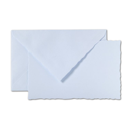G. Lalo Vergé de France card and envelope set in pale blue — deckle-edged flat card stacked with matching pale blue tissue-lined envelope on white background; diagonal euro flap open; deckle edge detail visible on card bottom