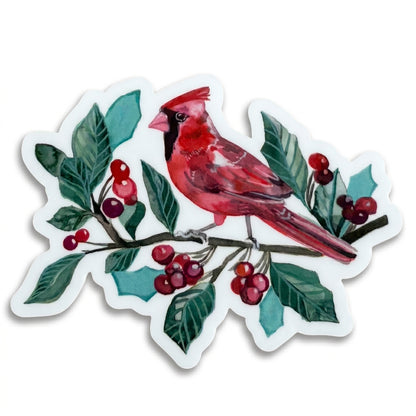 Made by Shellie Cardinal in Berries vinyl sticker — vivid watercolor male cardinal perched on a branch with deep green holly leaves, clusters of red berries, and teal accents; die-cut with white border; white background