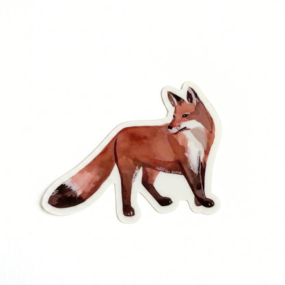 Made by Shellie Standing Fox vinyl sticker — detailed watercolor red fox in standing walking pose with rich russet coat, white chest, and dark-tipped bushy tail; die-cut with white border; white background

