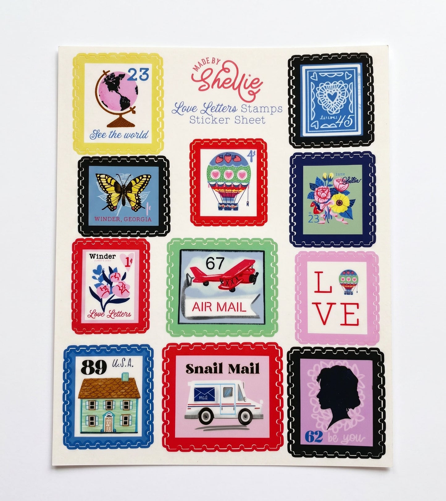 Made by Shellie Love Letters Stamps Sticker Sheet — 11 postage stamp-style stickers in colorful perforated frames including "See the World" globe, Winder Georgia butterfly, heart hot air balloon, Shellie floral bouquet, Winder 1¢ Love Letters stamp, Air Mail red biplane, LOVE stamp, 89¢ USA house, Snail Mail postal truck, blue lace heart stamp, and Victorian silhouette portrait; white background