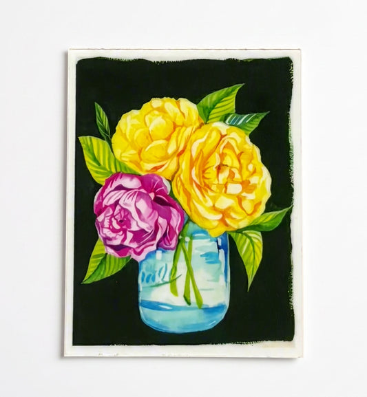 Made by Shellie Flowers in a Vase vinyl sticker — two bold yellow roses and one magenta rose with bright green leaves in a blue mason jar on a dramatic black background; rectangular with white border; white background
